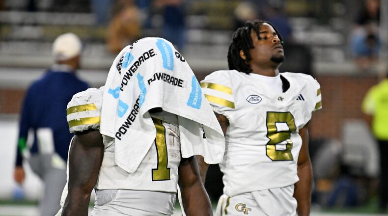 Georgia Tech running back Jamal Haynes (left) and wide receiver Malik Rutherford leave the field after Pittsburgh beat the Yellow Jackets on Saturday at Bobby Dodd Stadium. (Hyosub Shin/AJC)