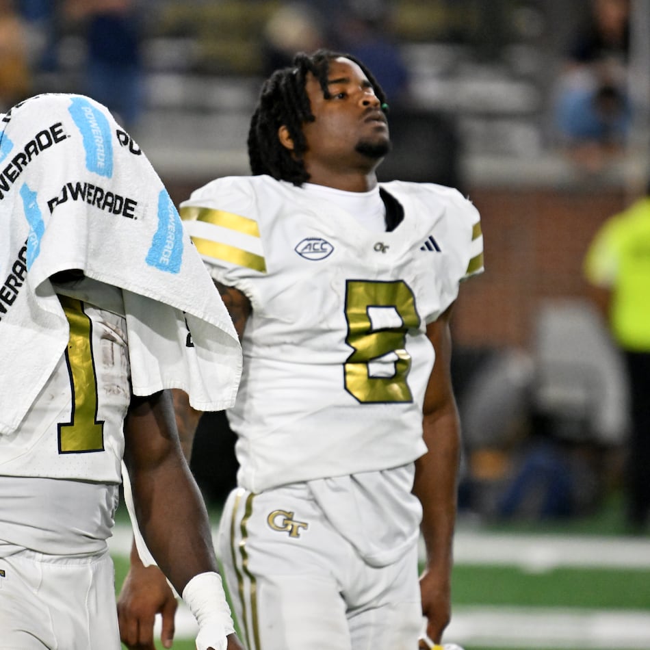 Georgia Tech running back Jamal Haynes (left) and wide receiver Malik Rutherford leave the field after Pittsburgh beat the Yellow Jackets on Saturday at Bobby Dodd Stadium. (Hyosub Shin/AJC)