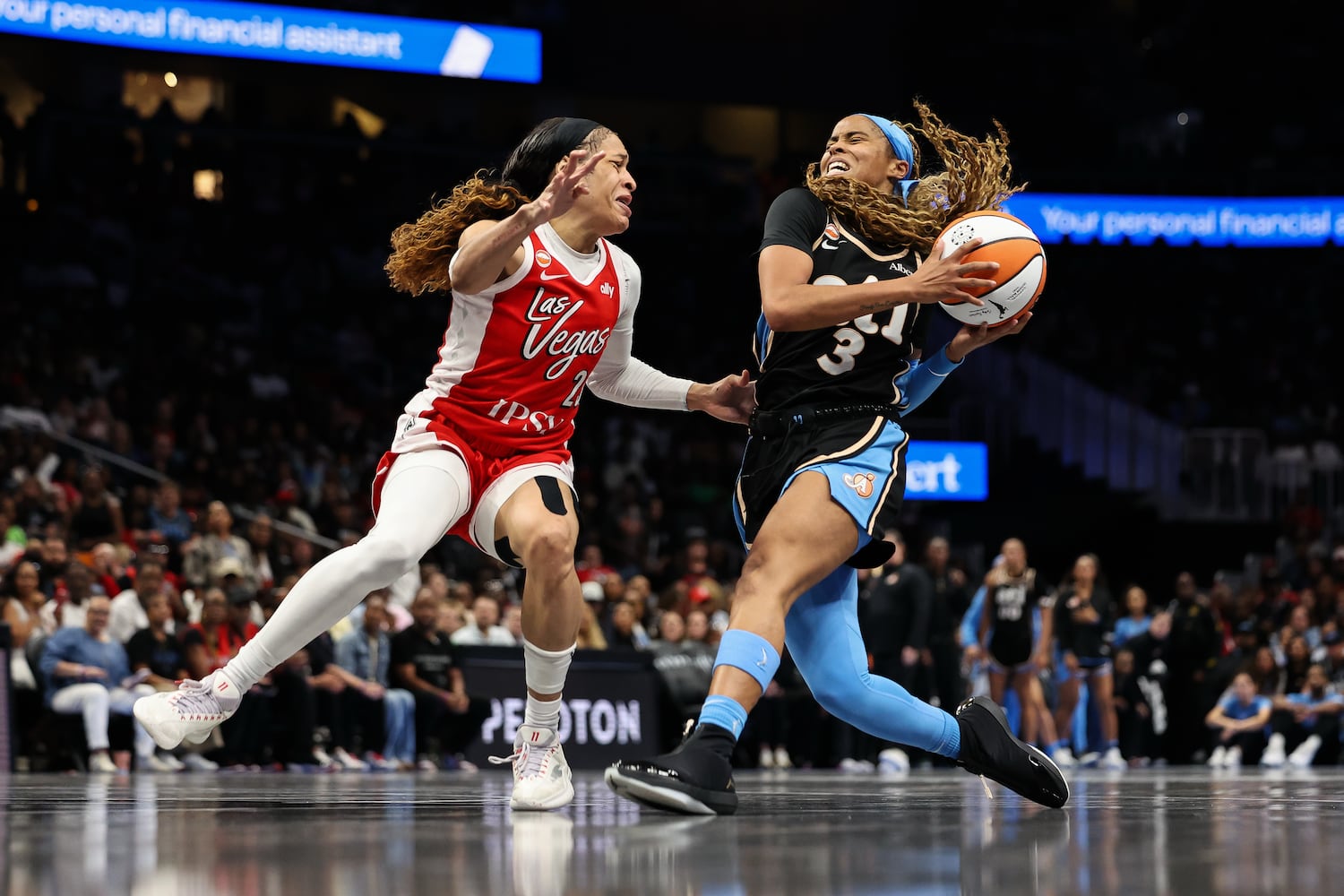 Dream guard Jordin Canada (right) drives to the basket against Aces guard Chennedy Carter on Sunday, May 17, 2026, at State Farm Arena in Atlanta. (Colin Hubbard for the AJC) 
