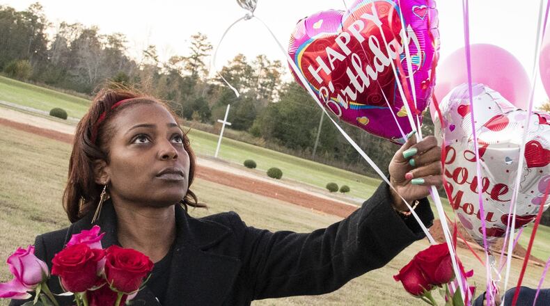 Cynthia Metts gathers balloons from her car for she and her siblings to take to their mother’s grave on her mother’s (Renee Metts) birthday, Monday, Nov.13, 2017 in Palmetto, Ga. Fulton County is terminating a contract it had for Morehouse School of Medicine to provide medical care for its inmates because, according to a letter, its doctors had failed to provide adequate care. Jail officials attribute at least five inmate deaths to that sub-par care. (Contributed by John Amis) AJC FILE PHOTO