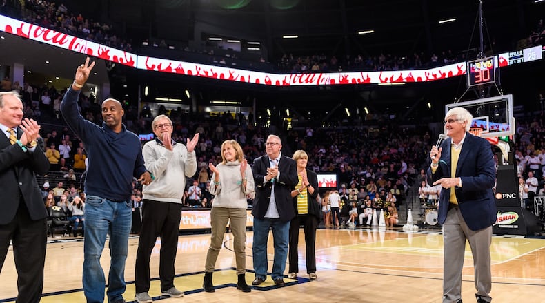 Georgia Tech great Kenny Anderson acknowledges the McCamish Pavilion crowd on Jan. 18, 2020 at halftime of a Yellow Jackets game against Virginia. Also pictured, from left to right: Phil Hanson (academic advisor), Anderson, Kevin Cantwell (assistant coach), Cathy Cantwell (wife of Kevin Cantwell), Frank Beall (director of basketball operations), Carolyn Cremins (wife of coach Bobby Cremins) and Cremins (holding the microphone). (Danny Karnik/Georgia Tech Athletic)