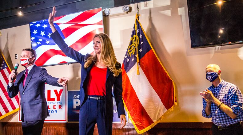 Senators David Perdue, left, Kelly Loeffler, center, and Florida Senator Rick Scott, right, joined together for a rally on Friday, November 13, 2020 at Black Diamond Grill in Cumming, GA.  Both Georgia candidates head to a run-off election in January.  (Jenni Girtman for The Atlanta Journal Constitution)
