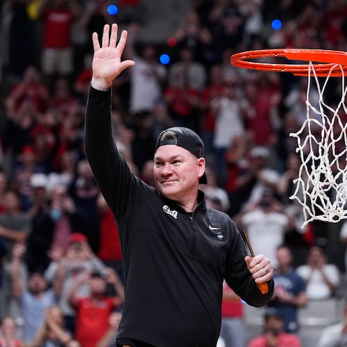 Arizona head coach Tommy Lloyd waves as he cuts down the net after a win over Purdue in the Elite Eight of the NCAA college basketball tournament, Saturday, March 28, 2026, in San Jose, Calif. (AP Photo/Godofredo A. Vásquez)