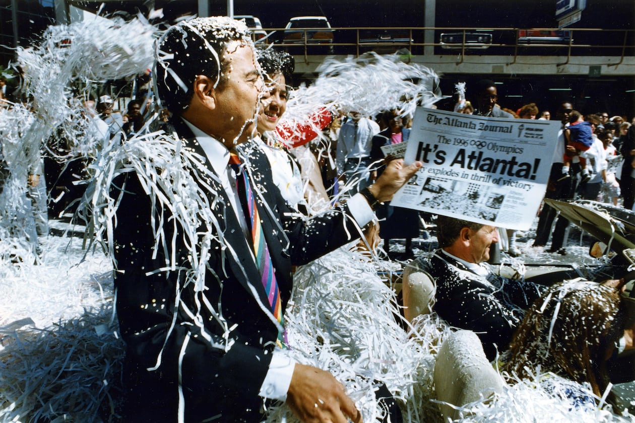 Former Mayor Andrew Young rides down Marietta Street in the Atlanta Olympic Day parade on Sept. 24, 1990. (Eric Williams/AJC File)