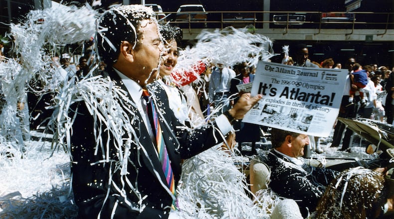 Former Mayor Andrew Young rides down Marietta Street in the Atlanta Olympic Day parade on Sept. 24, 1990. (Eric Williams/AJC File)