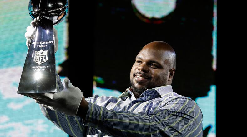 Vince Wilfork holds the Vince Lombardi Trophy as he helps with delivery of the trophy at the NFL Experience in 2017 in Houston.