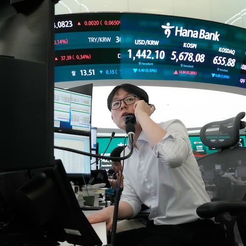 A currency trader talks on the phone at the foreign exchange dealing room of the Hana Bank headquarters in Seoul, South Korea, Thursday, July 30, 2026. (AP Photo/Ahn Young-joon)
