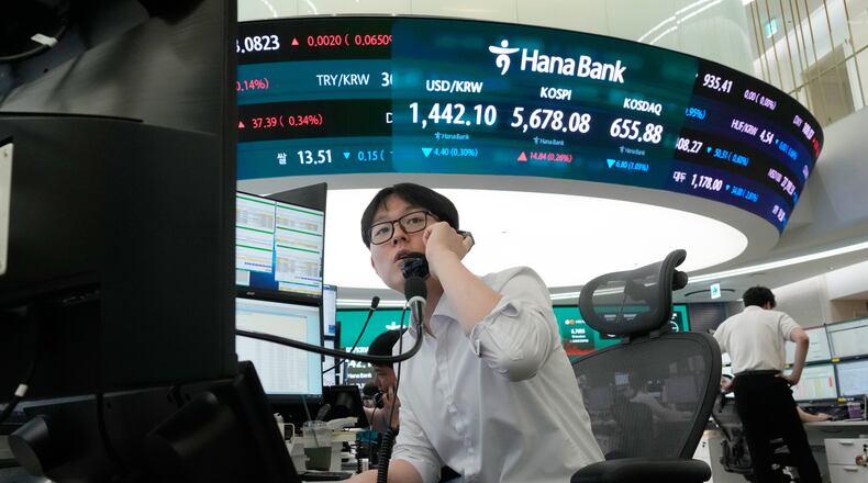 A currency trader talks on the phone at the foreign exchange dealing room of the Hana Bank headquarters in Seoul, South Korea, Thursday, July 30, 2026. (AP Photo/Ahn Young-joon)