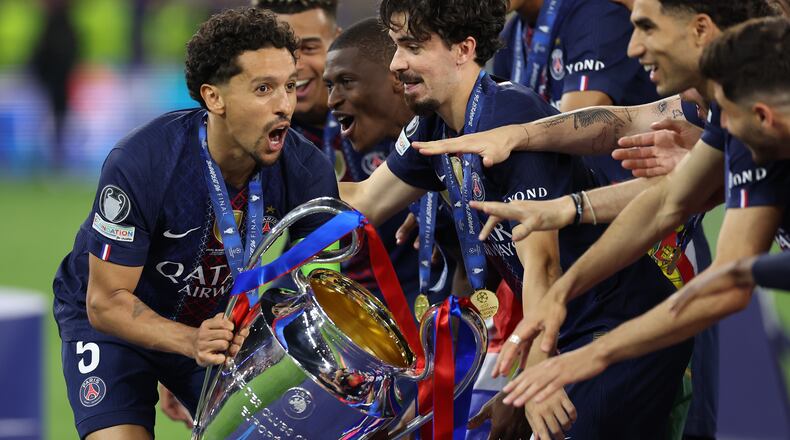 PSG players celebrate with a trophy after the Champions League final soccer match between Paris Saint-Germain and Arsenal in Budapest, Hungary, Saturday, May 30, 2026. AP Photo/Armin Durgut)