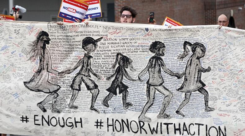 Activists hold up signs at the Florida State Capitol as they march for gun reform legislation on February 26, 2018 in Tallahassee, Florida. In the wake of the February 14 school shooting that left 17 people dead, hundreds of people joined the Parkland students to call for gun reform. (Photo by Don Juan Moore/Getty Images)