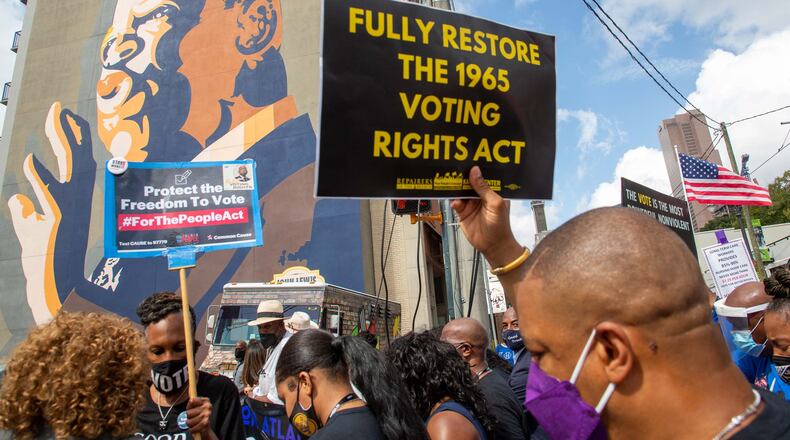 The March On For Voting Rights march reaches the John Lewis mural on Auburn Avenue in Atlanta on Saturday, August 28, 2021. STEVE SCHAEFER FOR THE ATLANTA JOURNAL-CONSTITUTION