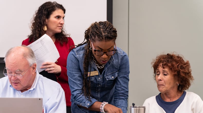 Cobb County Board of Elections chair Tori Silas (center) and assistant secretary Debbie Fisher (right) speak before a board meeting at the Cobb County Safety Village in Marietta on Aug. 3, 2024. (Seegar Gray/AJC)