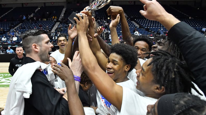 Sandy Creek's head coach Jon-Michael Nickerson (left) and players celebrate their victory over Cedar Grove during 2023 GHSA Basketball Class 3A Boy’s State Championship game at the Macon Centreplex, Friday, March 10, 2023, in Macon, GA. Sandy Creek won 66-38 over Cedar Grove. (Hyosub Shin / Hyosub.Shin@ajc.com)