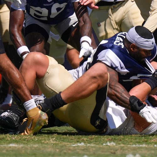 Dallas Cowboys outside linebacker Sam Williams, top, fight with New Orleans Saints tight end Moliki Matavao during an NFL football joint practice, Tuesday, Aug. 18, 2026, in Oxnard, Calif. (AP Photo/Mark J. Terrill)