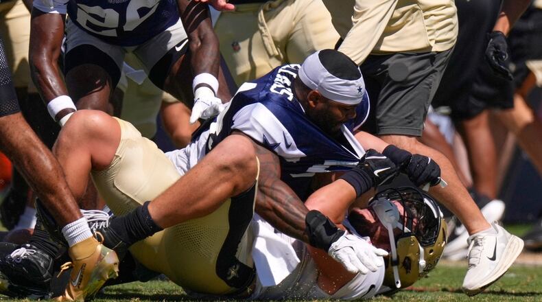 Dallas Cowboys outside linebacker Sam Williams, top, fight with New Orleans Saints tight end Moliki Matavao during an NFL football joint practice, Tuesday, Aug. 18, 2026, in Oxnard, Calif. (AP Photo/Mark J. Terrill)