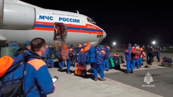 In this photo taken from video released by Russian Emergency Ministry Press Service on Saturday, March 29, 2025, Russian Emergency Ministry employees gather to board one of two planes with rescuers to Myanmar following Friday's earthquake, from a Moscow airfield, Russia. (Russia Emergency Ministry press service via AP)