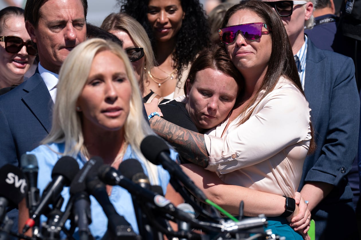 Epstein survivors Jena-Lisa Jones (center) and Haley Robson hug, as Rep. Marjorie Taylor Greene, R-Ga. (left) speaks during a news conference at the U.S. Capitol, Wednesday, Sept. 3, 2025, in Washington. (Jose Luis Magana/AP)