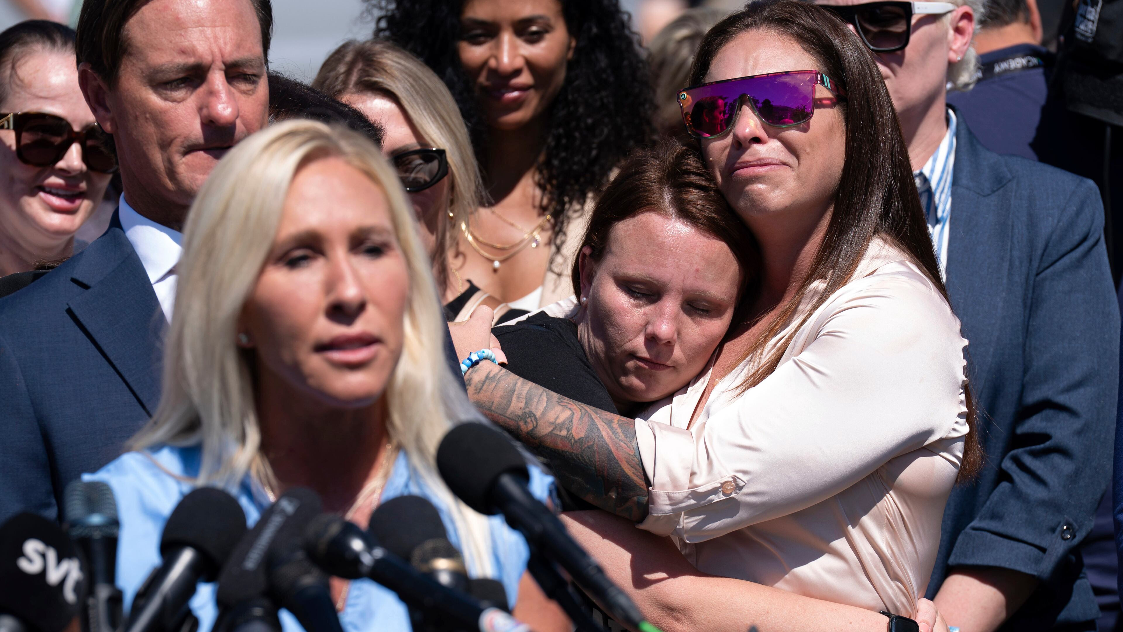 Epstein survivors Jena-Lisa Jones (center) and Haley Robson hug, as Rep. Marjorie Taylor Greene, R-Ga. (left) speaks during a news conference at the U.S. Capitol, Wednesday, Sept. 3, 2025, in Washington. (Jose Luis Magana/AP)