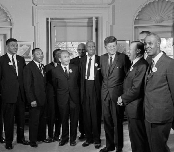 1963: President Kennedy poses at the White House with a group of leaders of the March on Washington. (From left) Whitney Young, Dr. Martin Luther King Jr., John Lewis, Rabbi Joachim Prinz, Dr. Eugene P. Donnaly, A. Philip Randolph, Kennedy; Walter Reuther, Vice-President Johnson (rear), and Roy Wilkins. (File/AP)