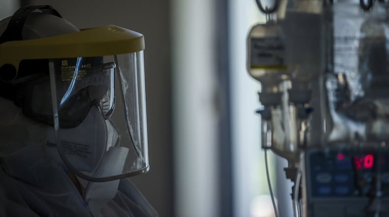A nurse in protective gear works at an intensive care unit for coronavirus patients in Budapest, Hungary, during the pandemic of the coronavirus COVID-19, Thursday, April 23, 2020. (Zoltan Balogh/MTI via AP)