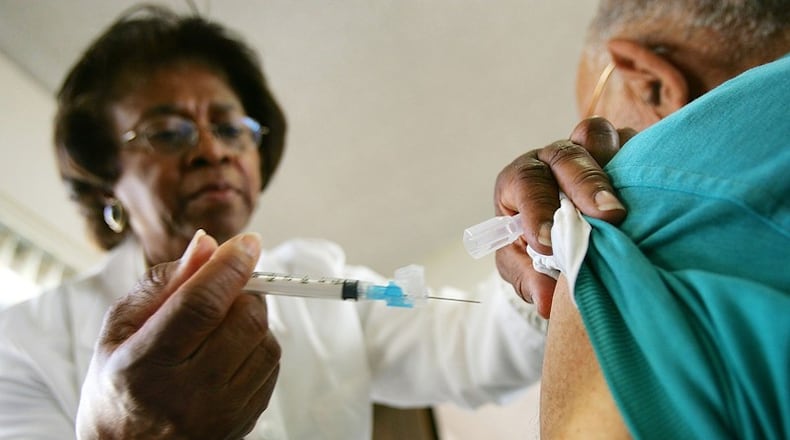 Emily Moore administers an inoculation against the flu