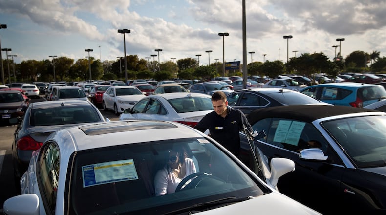 A salesman shows cars at a dealership in Doral, Fla., on March 14, 2017. (Scott McIntyre/The New York Times)