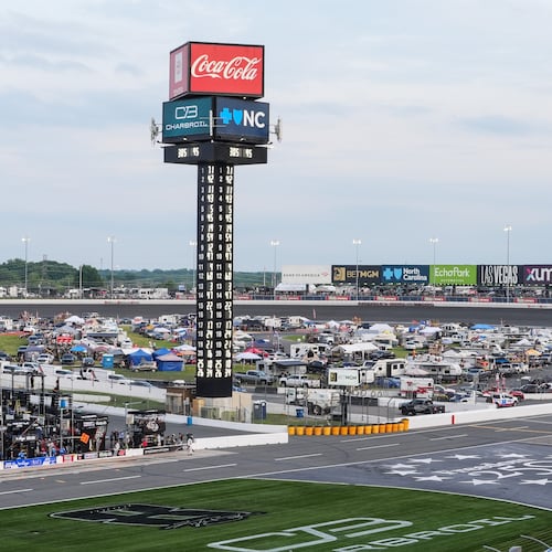 A pack of cars compete down the front stretch during a NASCAR Cup Series auto race, Sunday, May 24, 2026, in Charlotte, N.C. (AP Photo/Matt Kelley)