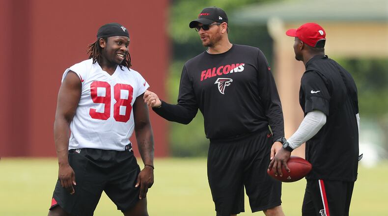 Falcons rookie defensive end Takkarist McKinley talks with team staffers during rookie minicamp on Friday. Curtis Compton/ccompton@ajc.com