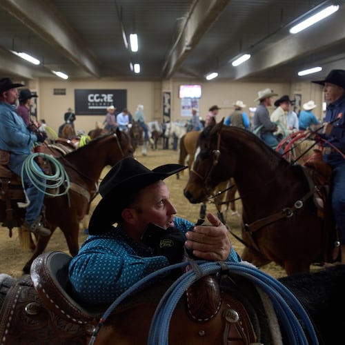 Contestants wait to compete during the World Series of Team Roping at the South Point hotel-casino in Las Vegas Tuesday, Dec. 9, 2025, in Las Vegas. (AP Photo/John Locher)