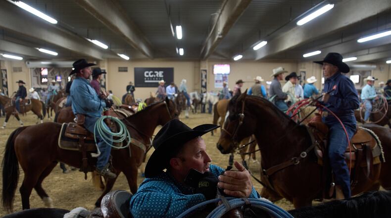 Contestants wait to compete during the World Series of Team Roping at the South Point hotel-casino in Las Vegas Tuesday, Dec. 9, 2025, in Las Vegas. (AP Photo/John Locher)