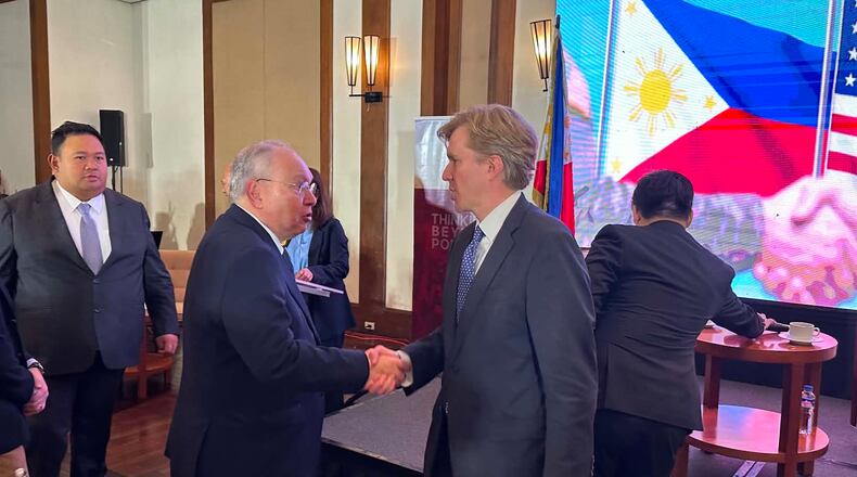 United States Undersecretary of Defense for Policy Elbridge Colby, right, shakes hands with Philippine Ambassador to the U.S., Jose Manuel Romualdez during a forum in Manila, Philippines on Monday, Aug. 10, 2026. (AP Photo/Joeal Calupitan)