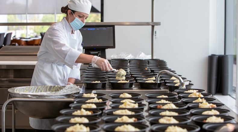 Arielle Grant helps prepare 250 shepherd’s pies in the kitchen at the Mercedes-Benz USA headquarters in Sandy Springs for a Second Helpings Atlanta delivery. PHIL SKINNER FOR THE ATLANTA JOURNAL-CONSTITUTION.