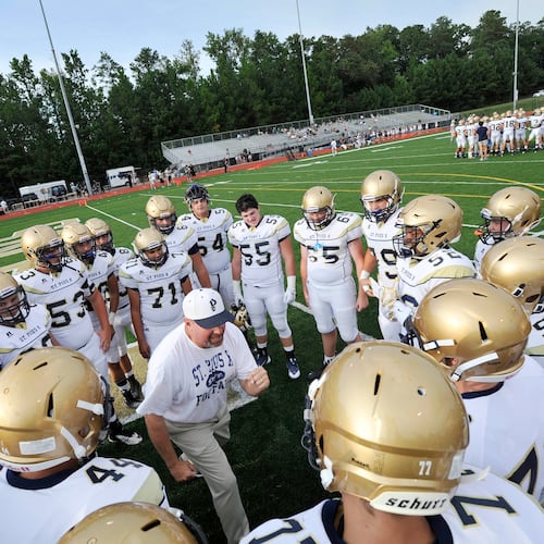 St. Pius football coach Chad Garrison gives a pre-game talk to team members before taking on Blessed Trinity, in Roswell. (John Amis for the AJC 2015)