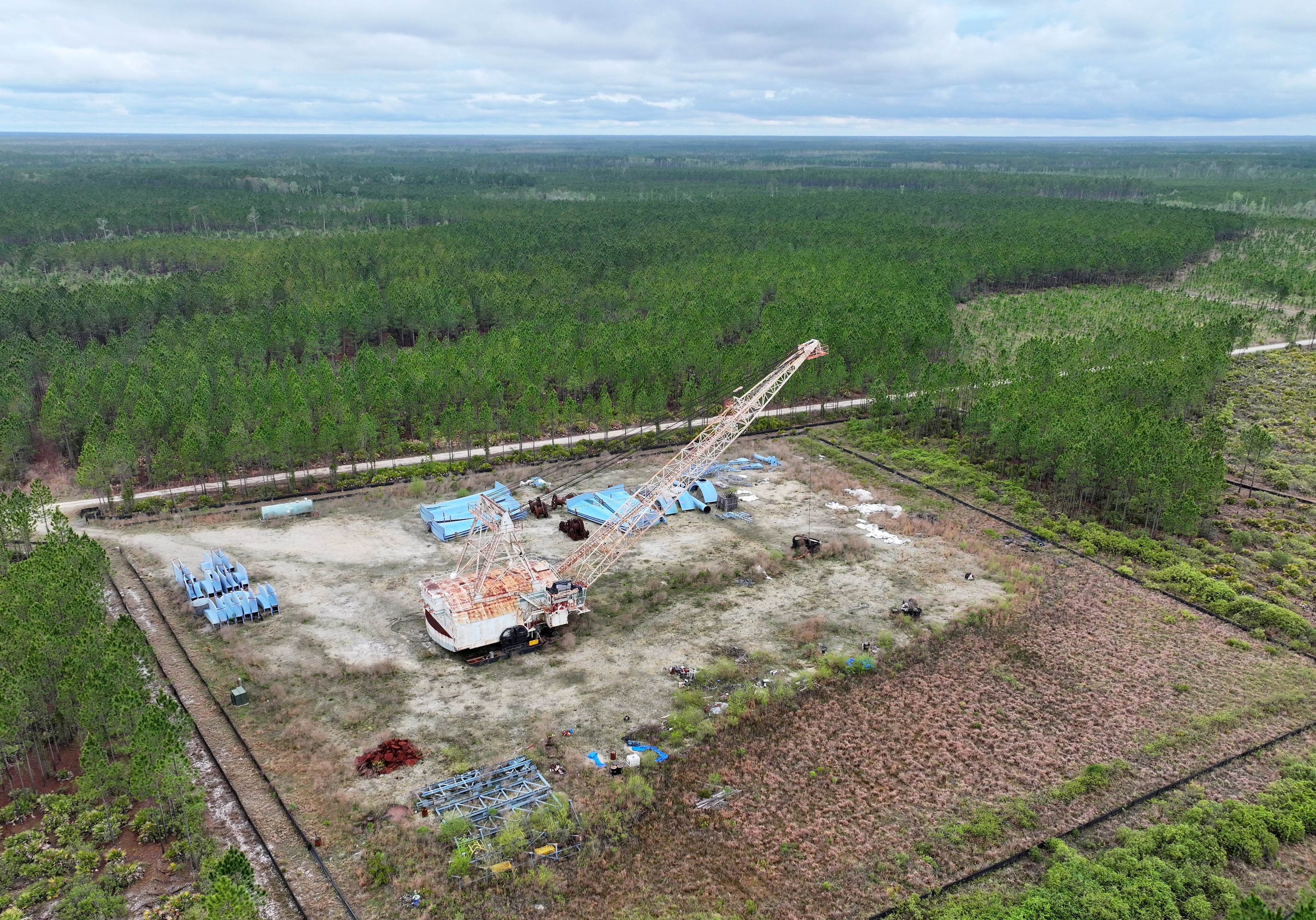 A drone photograph shows the Twin Pines mine site with equipment stationed on Mar. 18, 2024, in Charlton County. The site is located less than 3 miles from the Okefenokee National Wildlife Refuge. (Hyosub Shin/AJC)