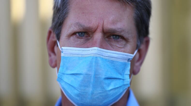 Gov. Brian Kemp wears a mask and urges all Georgians to do the same as the coronavirus surges. But he resists calls to make masks mandatory. (CURTIS COMPTON / ccompton@ajc.com)