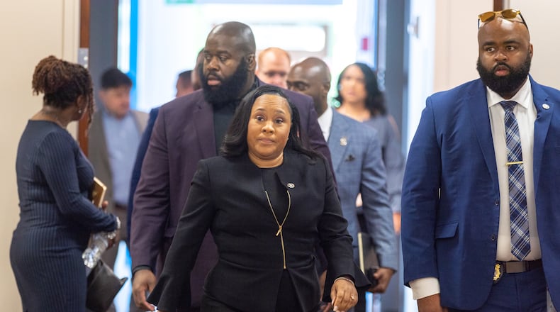 Fulton County District Attorney Fani Willis (center) enters the jury assembly room at Fulton County Courthouse in Atlanta on Tuesday, July 11, 2023. Two Fulton County grand juries are being selected, one of which will be expected to decide whether to hand up an indictment in the long-running investigation into alleged meddling with the 2020 presidential election. (Arvin Temkar / arvin.temkar@ajc.com)