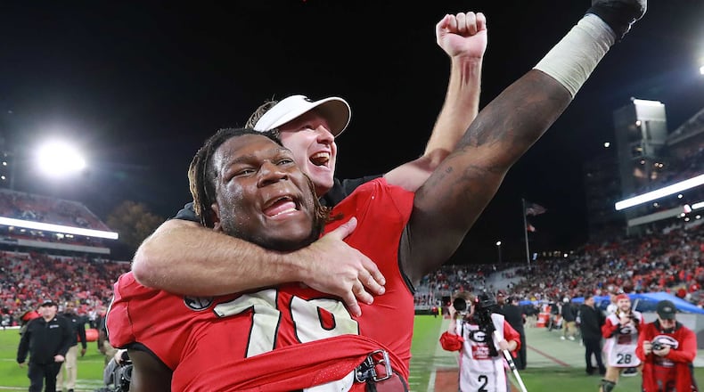 Georgia head coach Kirby Smart jumps on the back of offensive lineman Isaiah Wilson to celebrate beating Texas A&M 19-13 on Saturday, November 23, 2019, in Athens. Curtis Compton/ccompton@ajc.com