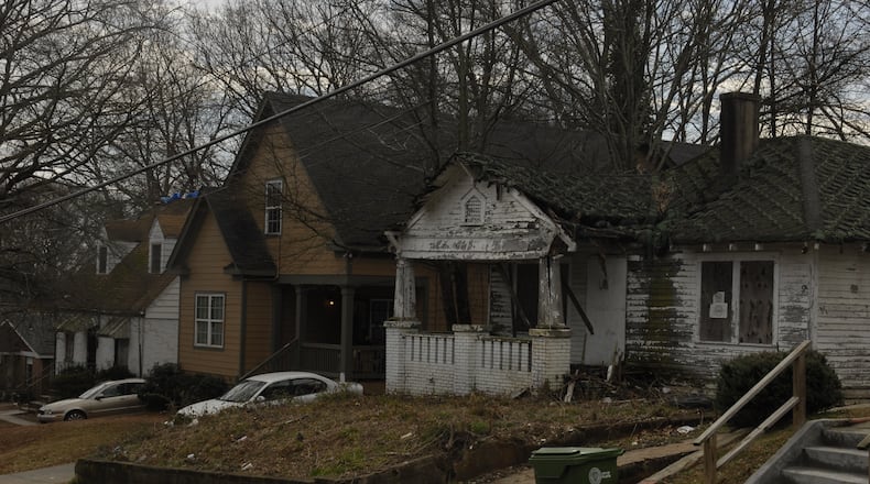 This AJC file photo from March 2015 shows abandoned and broken-down houses situated next to well-maintained family homes in Atlanta's Pittsburgh community. The 2008-2010 subprime mortgage fraud crisis left nearly half the homes vacant in the Pittsburgh neighborhood. Pittsburgh homeowners, Invest Atlanta, the Annie E. Casey Foundation and Wells Fargo are working to revitalize Pittsburgh. (Photo by J. Scott Trubey / strubey@ajc.com)