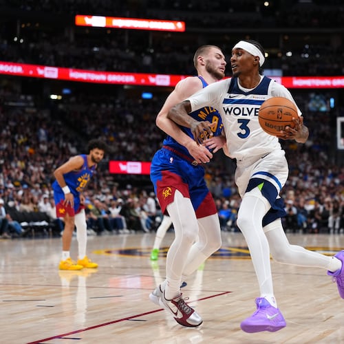 Minnesota Timberwolves Jaden McDaniels (3) drives to the basket against Denver Nuggets guard Christian Braun (0) during the second half in Game 2 of a first-round NBA playoffs basketball series Monday, April 20, 2026, in Denver. (AP Photo/Jack Dempsey) CORRECTION Correct to Julius Randle in stead of Julius Randle.