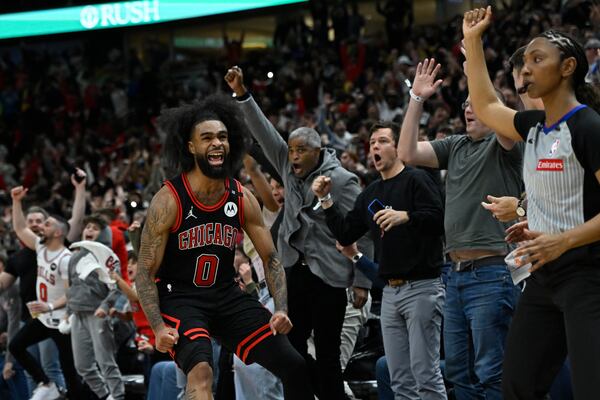 Chicago Bulls' Coby White (0) celebrates after making a three-point basket during the final seconds of an NBA basketball game against the Los Angeles Lakers Thursday, March 27, 2025, in Chicago. (AP Photo/Paul Beaty)