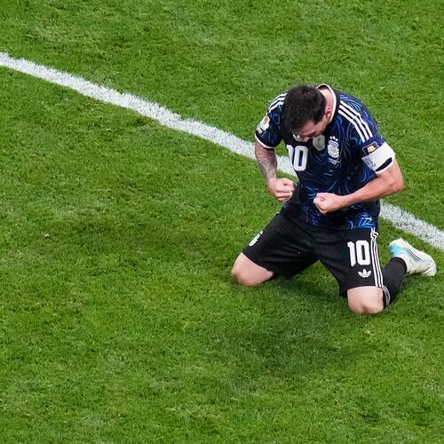 Argentina's Lionel Messi (10) kneels on the pitch as he celebrates defeating England in their World Cup semifinal soccer match in Atlanta, Wednesday, July 15, 2026. (AP Photo/Lynne Sladky)