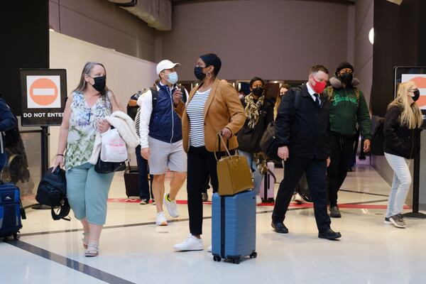 Travelers are seen at Hartsfield-Jackson airport in Atlanta on Friday, April 8, 2022.   (Arvin Temkar / arvin.temkar@ajc.com)
