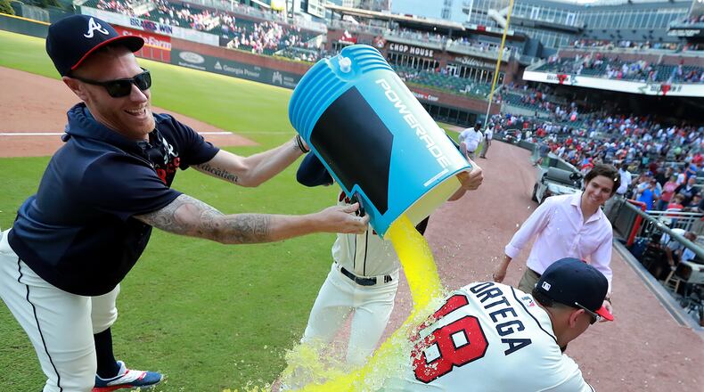 Braves pitcher Mike Foltynewicz (left) and outfielder Matt Joyce celebrate Rafael Ortega’s grand slam after Sunday’s 5-3 win over the Dodgers.
