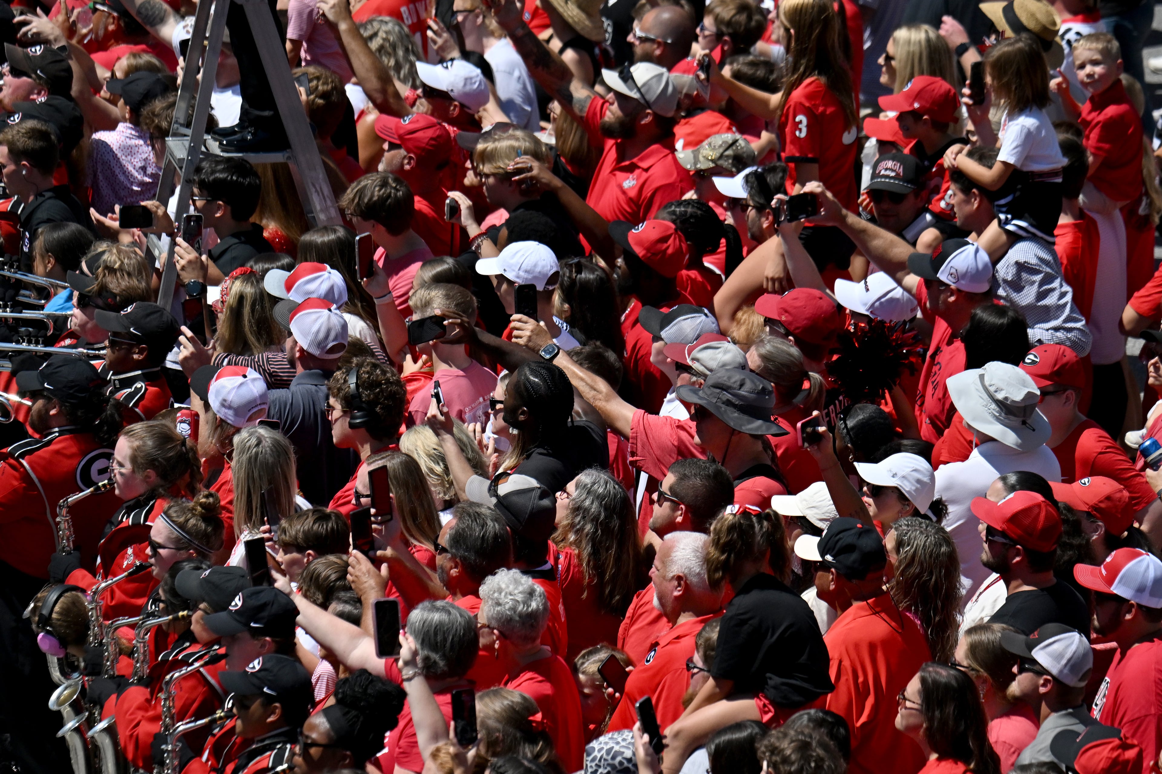 Georgia fans cheer as players and staff arrive during Dawgs Walk before Georgia football's season opener and home opener against Marshall at Sanford Stadium, Saturday, August 30, 2025, in Athens. (Hyosub Shin / AJC)