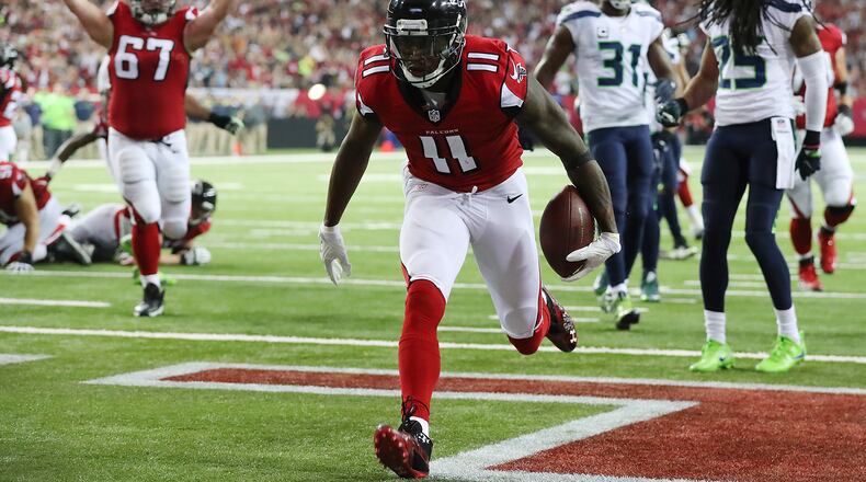 Falcons wide receiver Julio Jones scores a touchdown against the Seahawks to tie the score at 7-7 during the first quarter in a NFC divisional playoff game on Saturday, Jan. 14, 2017, in Atlanta. (Curtis Compton/ccompton@ajc.com)