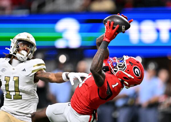 Georgia defensive back Ellis Robinson IV (right) intercepts a pass intended for Georgia Tech wide receiver Dean Patterson at Mercedes-Benz Stadium on Friday, Nov. 28, 2025, in Atlanta. Robinson needs refinement, but his ballhawk traits are rare. (Hyosub Shin/AJC)