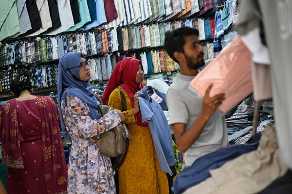 Women shop for clothes at a garments market in Dhaka, Bangladesh, Thursday, April 3, 2025. (AP Photo/Mahmud Hossain Opu)