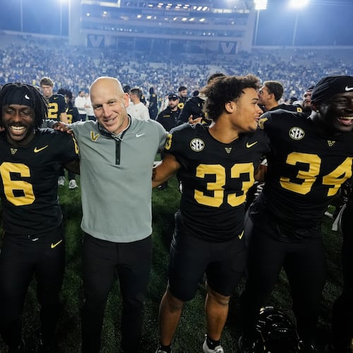 Vanderbilt head coach Clark Lea, center, celebrates the team's win with players after an NCAA college football game against Kentucky, Saturday, Nov. 22, 2025, in Nashville, Tenn. (AP Photo/George Walker IV)