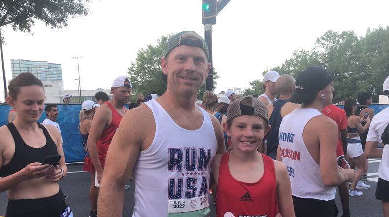 Brandon Young and son, Max, at Atlanta Journal-Constitution Peachtree Road Race on Monday, July 4, 2022.
