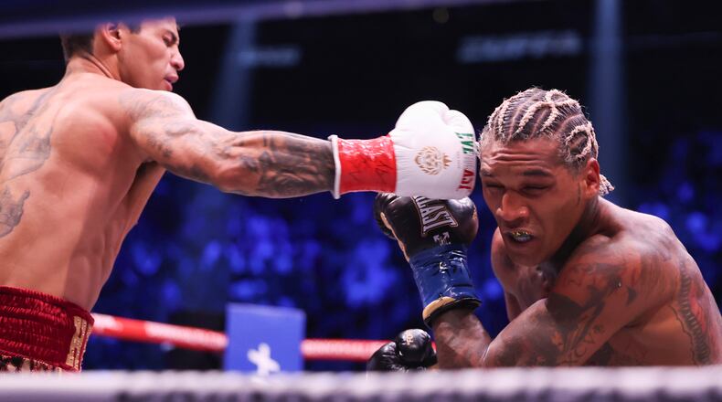 Ryan Garcia, left, punches Conor Benn in their welterweight championship fight Saturday, Sept. 12, 2026, in Las Vegas. (AP Photo/Ian Maule)